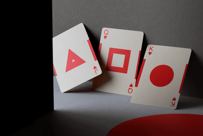 Three playing cards with unique symbols on a dark surface