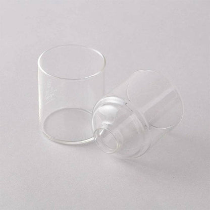Two clear glass cups on a light gray background