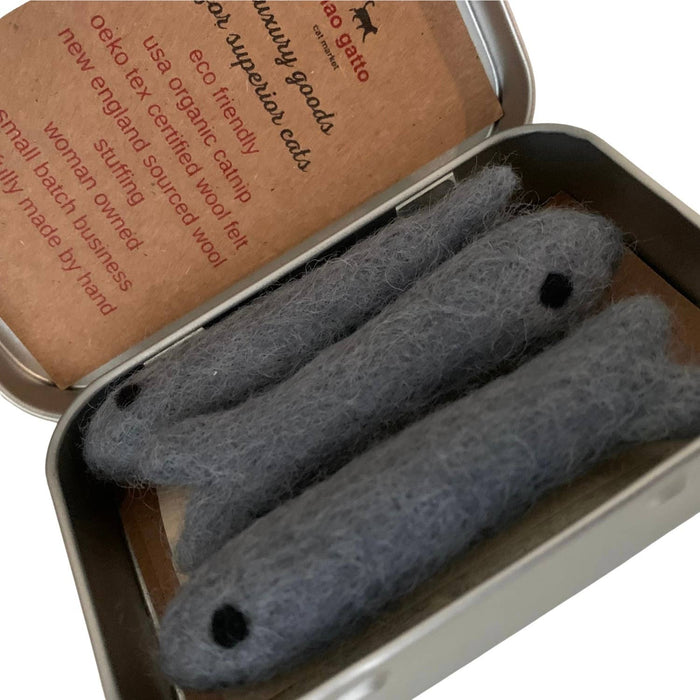 Three gray catnip toys in a metal tin with a brown label.