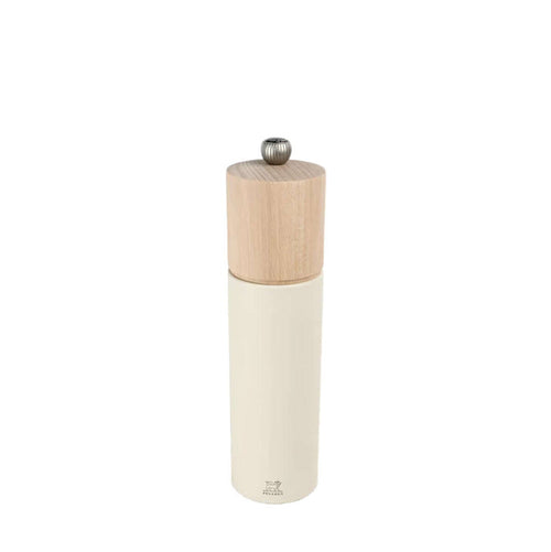 White salt grinder with wooden top on a white background