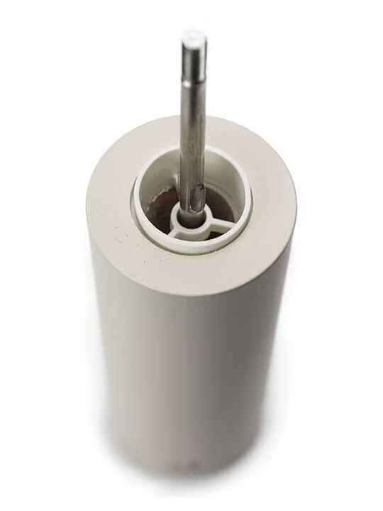 Inside view of white salt grinder with metal core on a white background