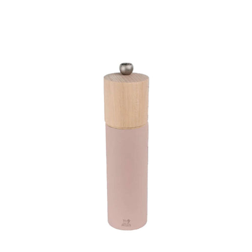 Pepper grinder with wooden top and pink body on a white background