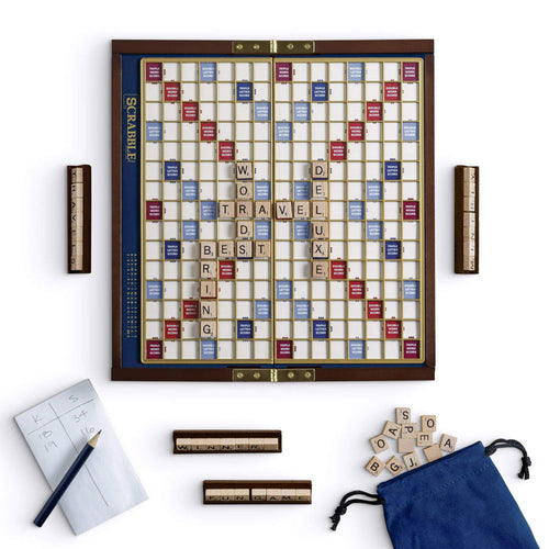 Scrabble board game with tiles and accessories on a white background