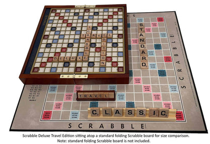 Scrabble Deluxe Travel Edition on a standard folding Scrabble board and two sets of tiles for size comparison.