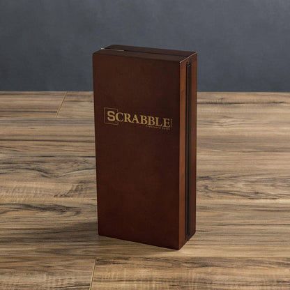 Brown wood Scrabble Travel Edition game box on a wooden surface with a dark gray background